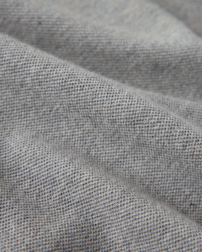 Heather grey polo shirt with textured cotton piqué weave fabric and collar detail.