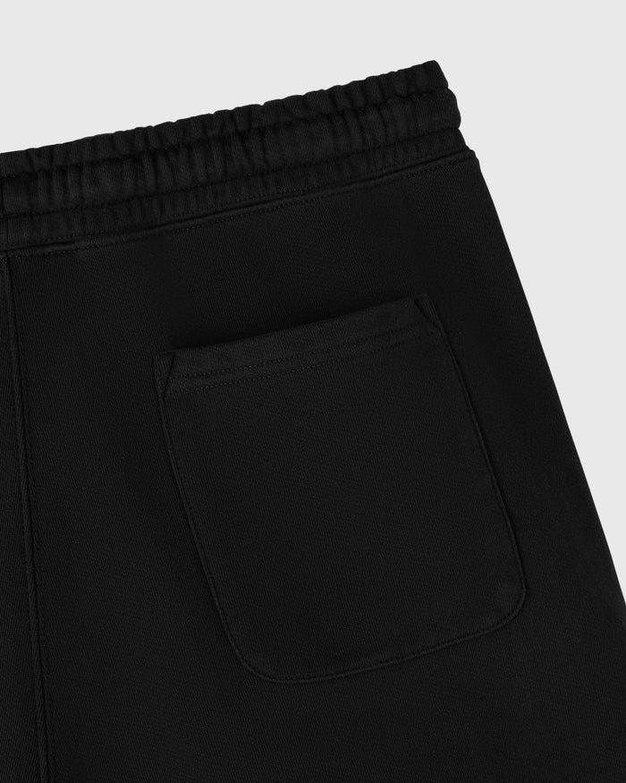 Black sweatpants with ribbed waistband and front pocket detail.