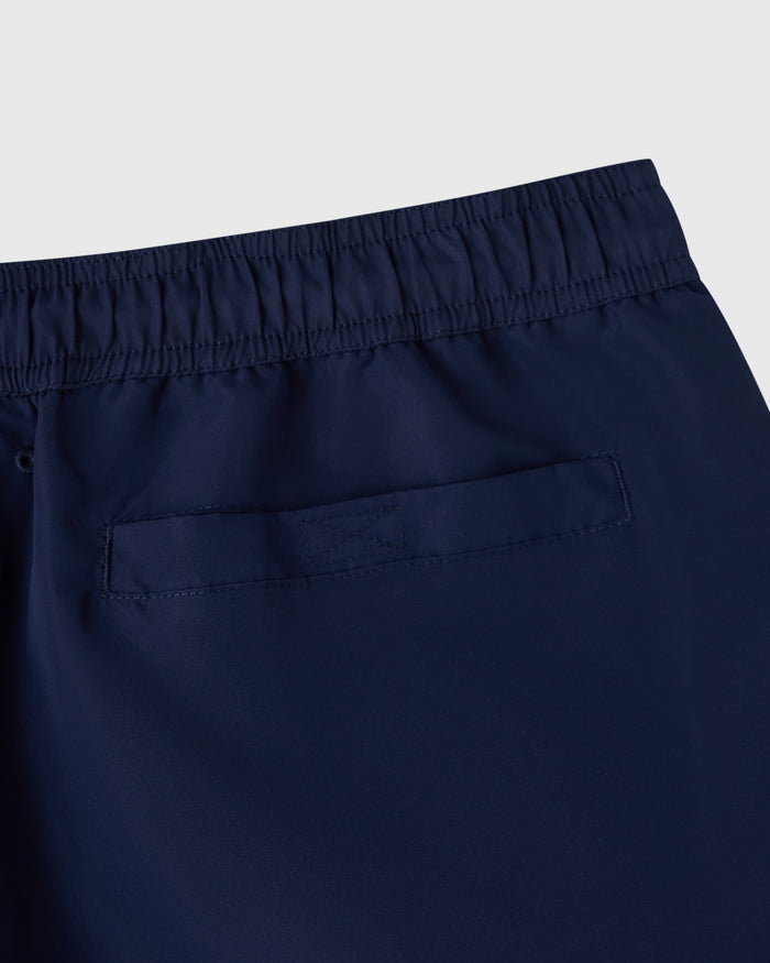 Navy swim short with elasticated waistband and patch pocket detail.