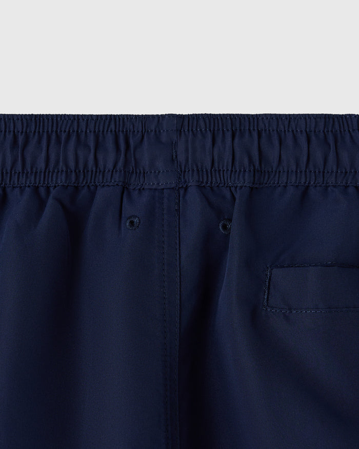 Navy swim shorts with elasticated waistband, drawstring, and rear patch pocket.
