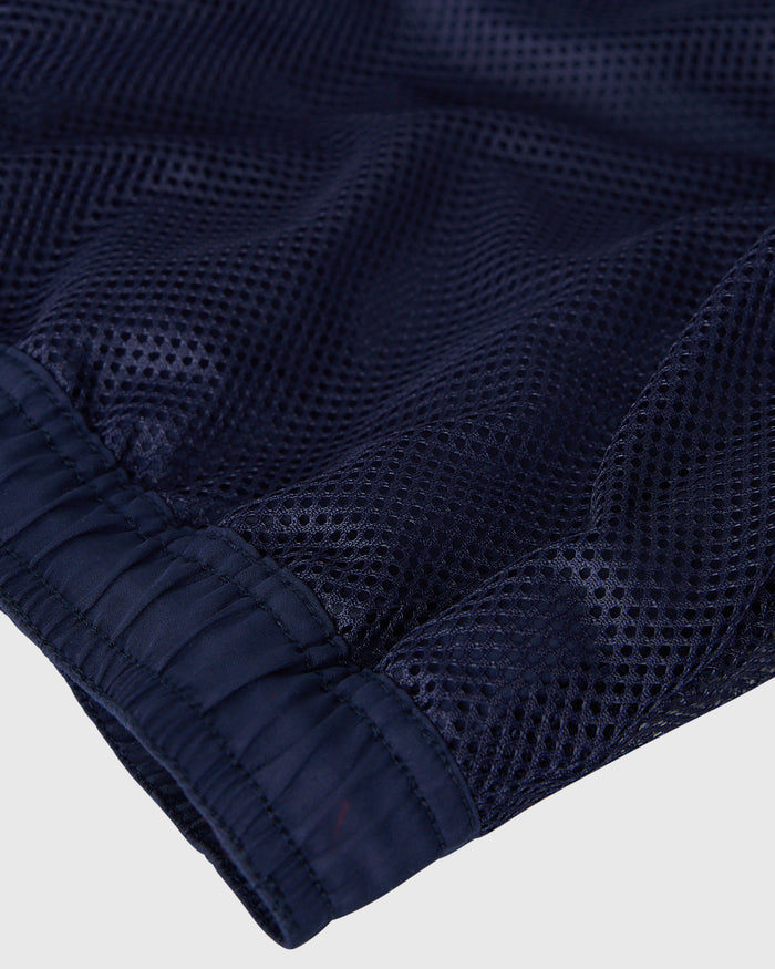 Navy swim short with textured mesh fabric and elastic waistband detail.