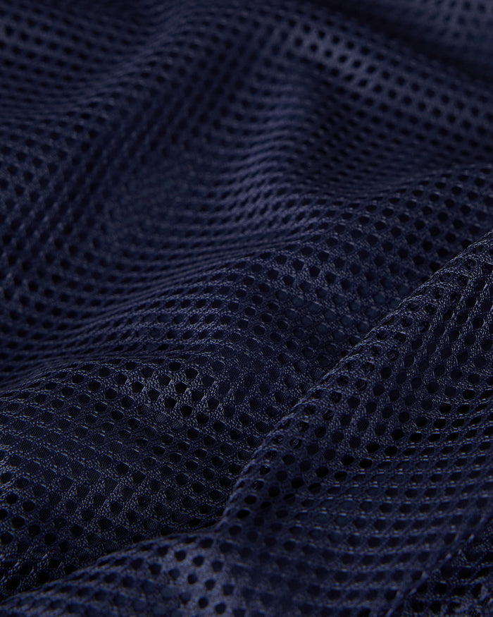 Navy mesh swim short fabric showing textured weave pattern and draping.