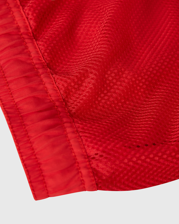 Red swim short with textured nylon fabric and elasticated waistband detail.
