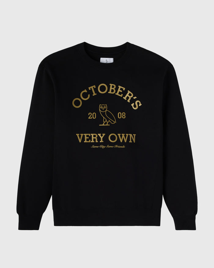 Black crewneck sweatshirt with gold text reading "October's Very Own" and an owl graphic.
