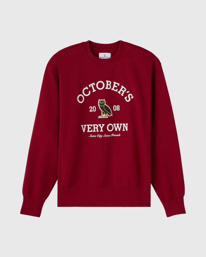 Deep red crewneck sweatshirt with white "Octobers Very Own" text and owl graphic on chest.