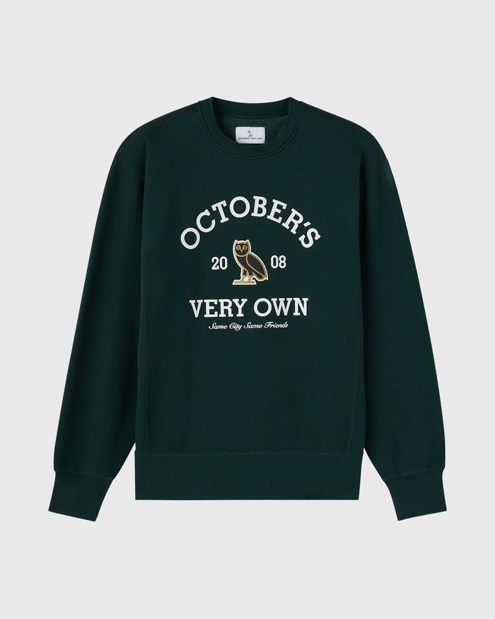 Midnight green crewneck sweatshirt with white text reading "October's 2008 Very Own" and an owl graphic.