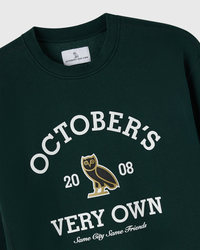 Midnight green crewneck sweatshirt with white "October's Very Own" text, owl graphic, and "2008" print.