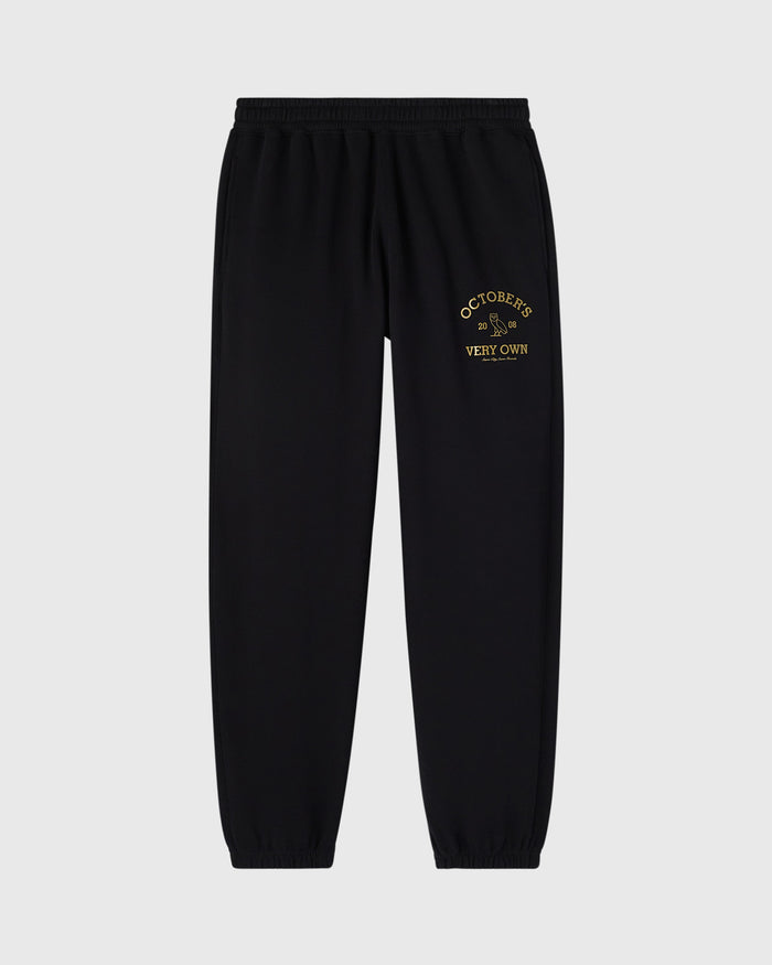 Black sweatpants with gold embroidered "Octobers Very Own" text on thigh.