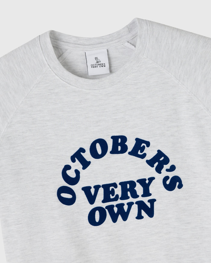 Heather grey raglan tee with dark blue "October's Very Own" text graphic on chest.