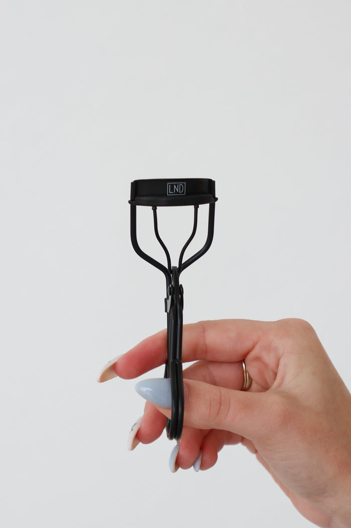 girl holding LND eyelash curler