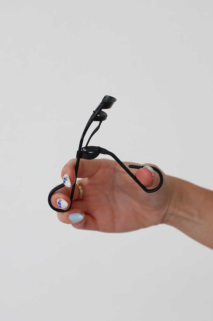 girl holding LND eyelash curler