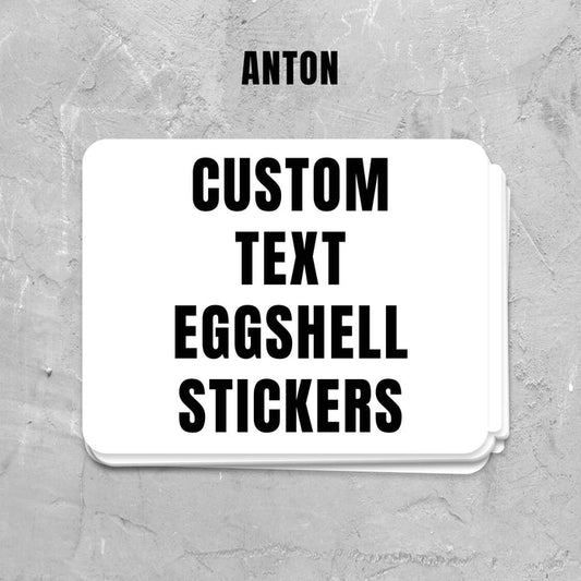Stack of custom text eggshell stickers on a gray textured background with 'ANTON' branding.