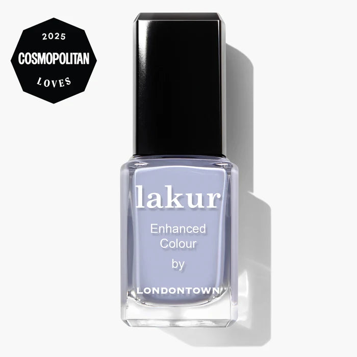 A bottle of LONDONTOWN Dainty Daze vegan nail polish in light purple, featuring a "2025 Cosmopolitan Loves" badge in the corner.
