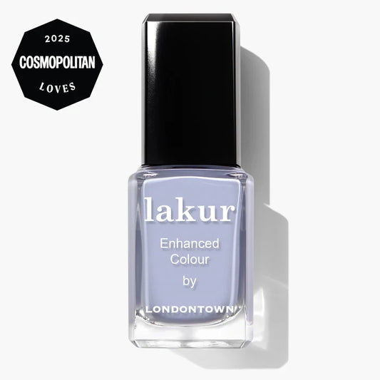 A bottle of LONDONTOWN Dainty Daze vegan nail polish in light purple, featuring a "2025 Cosmopolitan Loves" badge in the corner.