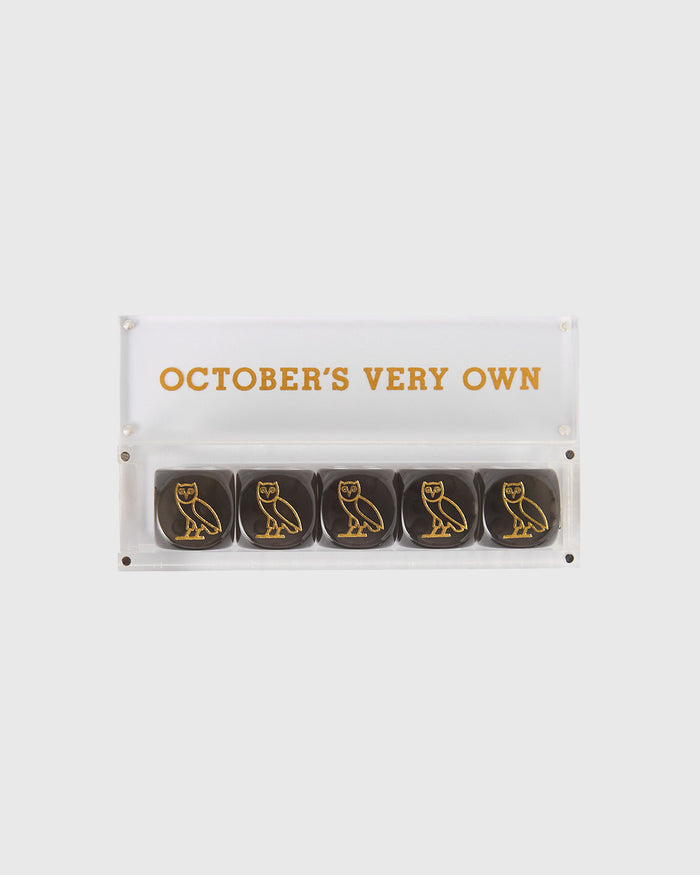 Five black dice with gold owl designs inside clear acrylic case labeled "October's Very Own."