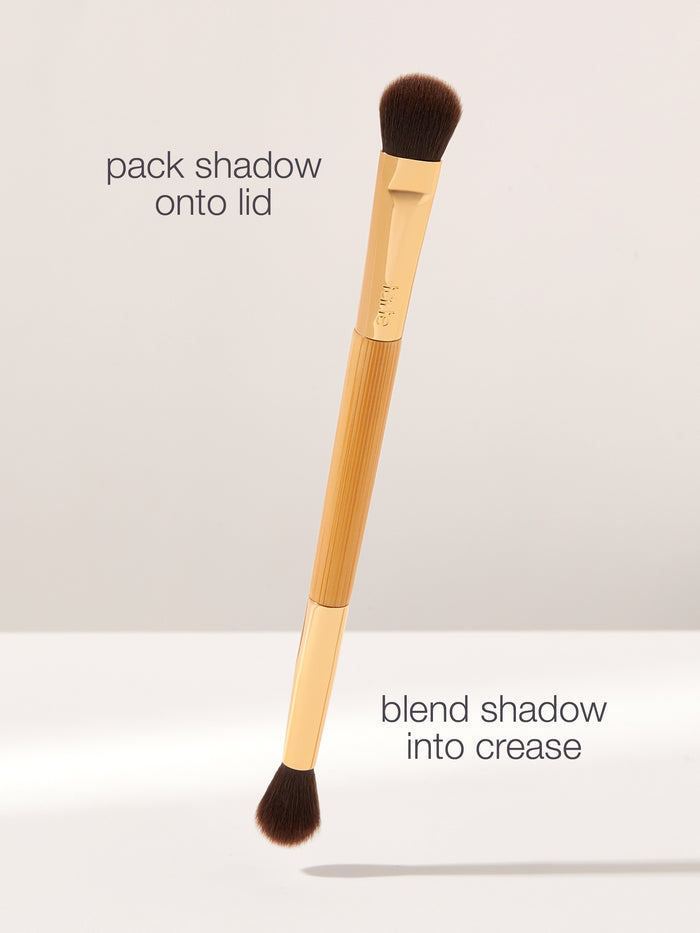 Makeup brush with text instructions on a light gray background