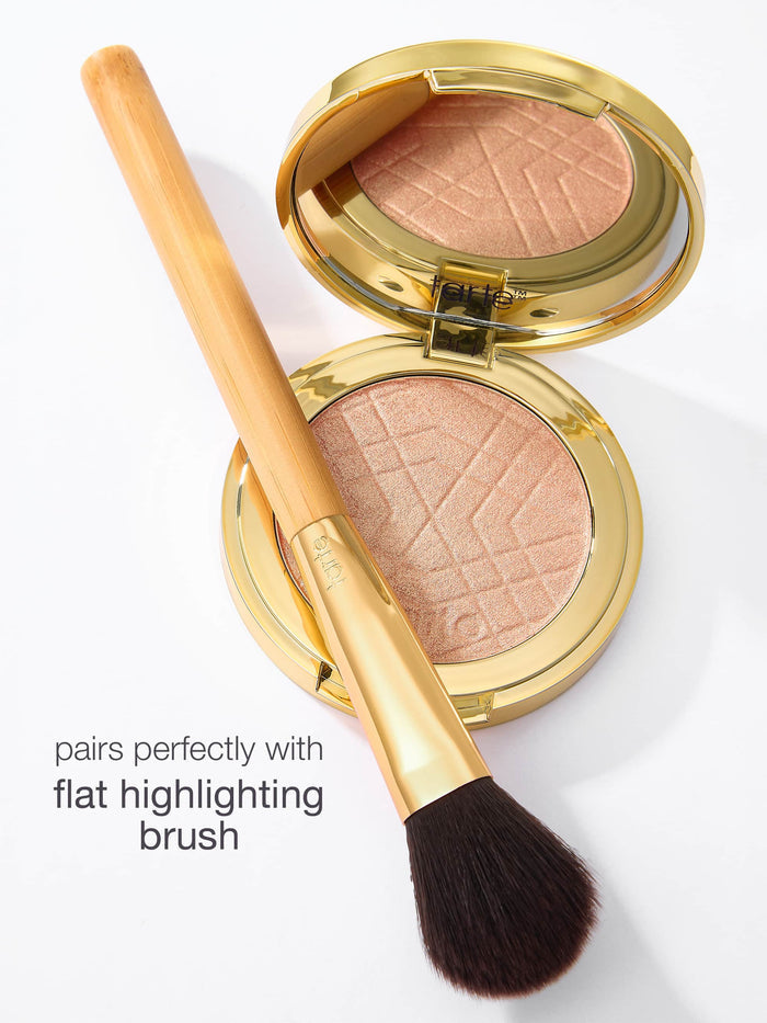 Compact blush with a brush on a white background