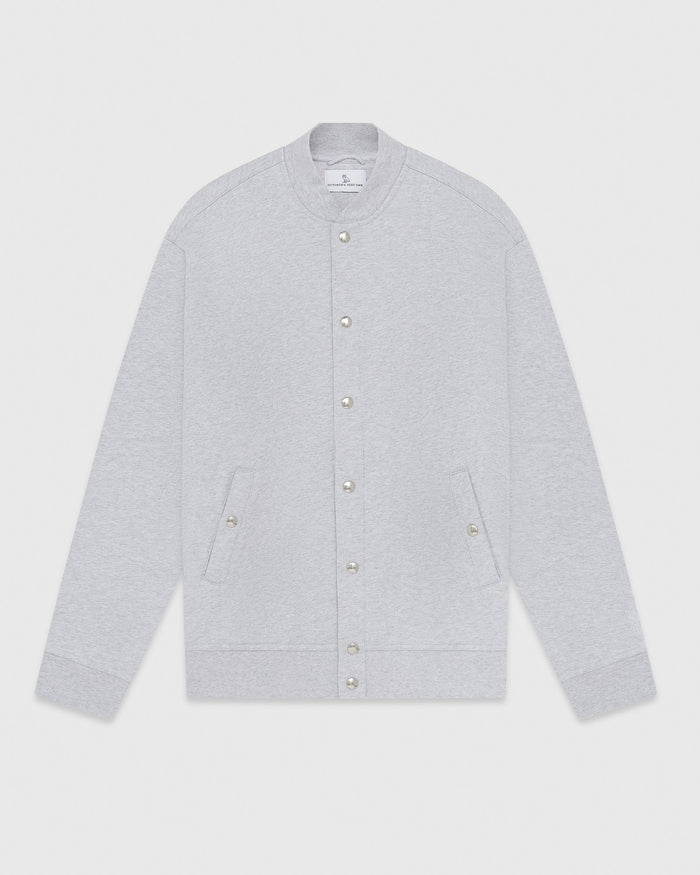 Light gray fleece varsity jacket with snap button front closure and side pockets.