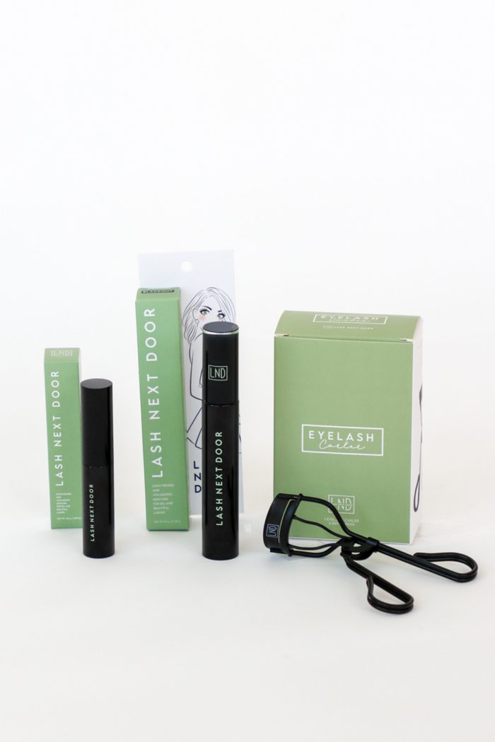 Eyelash extension kit with tools and packaging on a white background