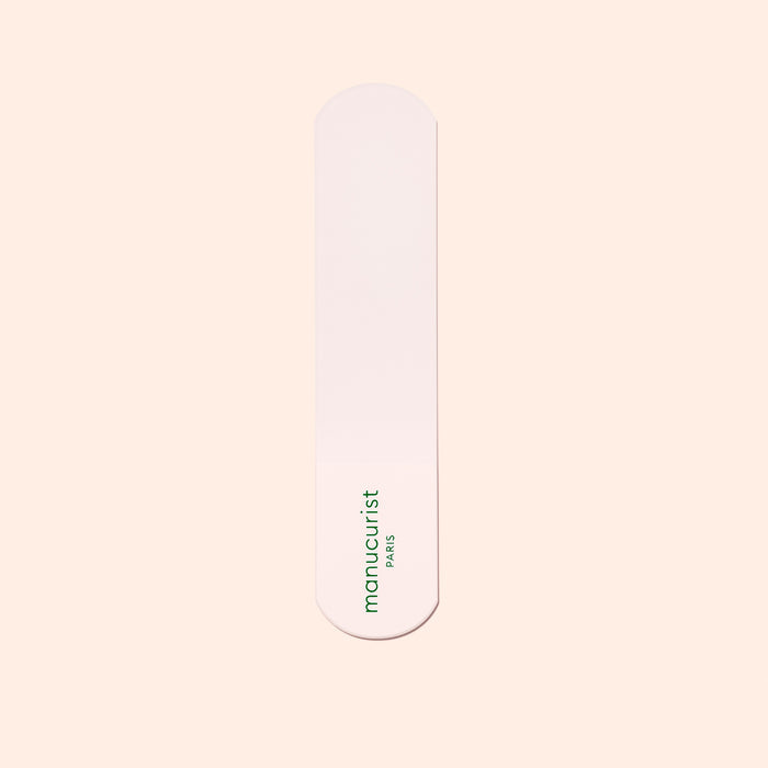 A single pink nail file with rounded ends and the green Manucurist-us logo, ideal for pairing with the Manucurist-us Glass Foot File to exfoliate heels and achieve soft, smooth skin.