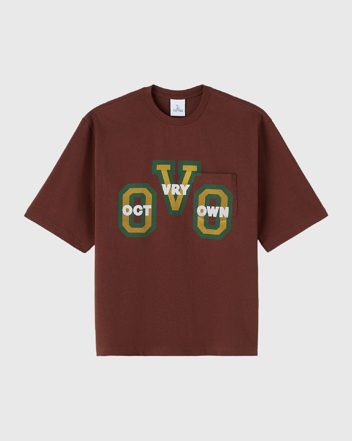 Hickory brown short-sleeve tee with chest pocket and "Oct VRY Own" graphic in green and gold.