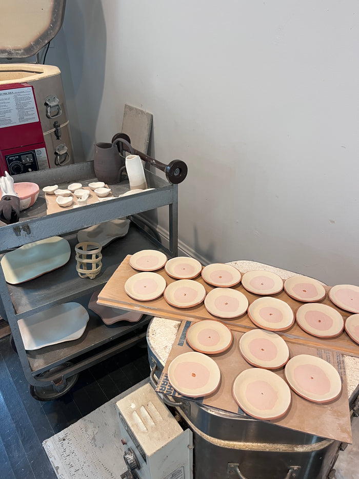 Wooden discs on a machine, likely in a workshop setting