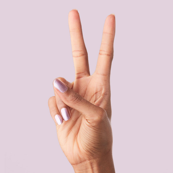 Hand showing two fingers painted with Lilac Shimmer for a delicate and metallic at-home manicure look