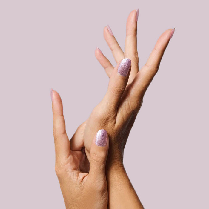 Nails painted with Lilac Shimmer polish in soft metallic purple for a delicate and elegant mani look at home