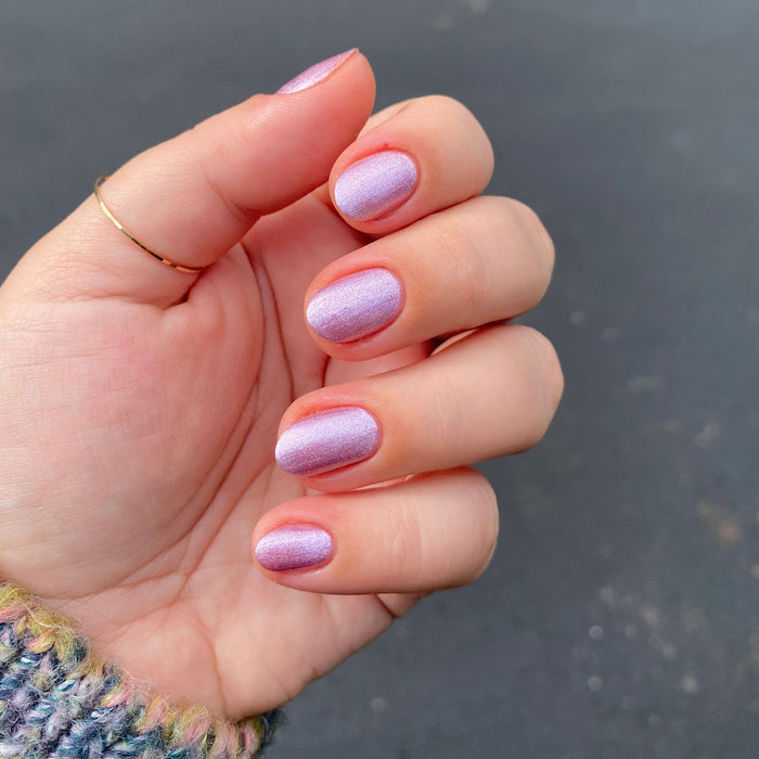 Fingernails painted in Lilac Shimmer showing a soft metallic purple manicure perfect for quick dry at-home polish looks