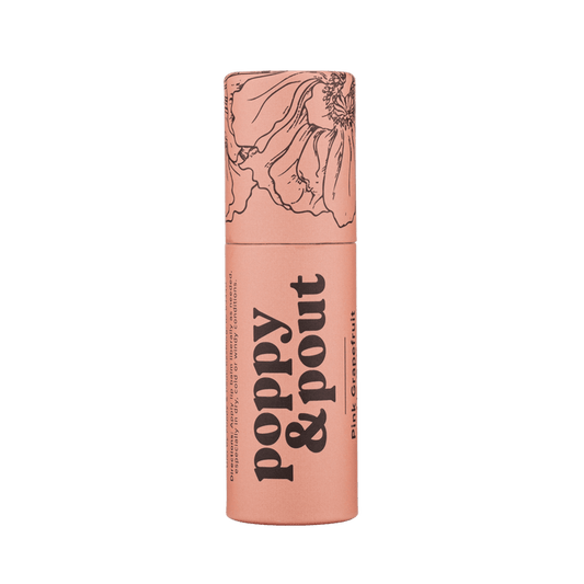 Peach pink lip balm tube with yellow cap and grapefruit-themed label