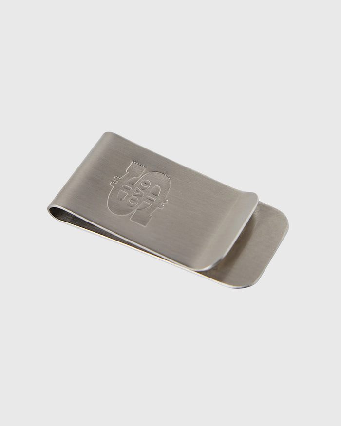 Silver metal money clip with engraved logo on brushed surface and curved clip mechanism.