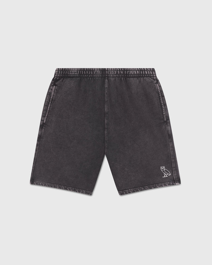 Charcoal garment-dyed shorts with elastic waistband, side pockets, and small owl logo on right leg.