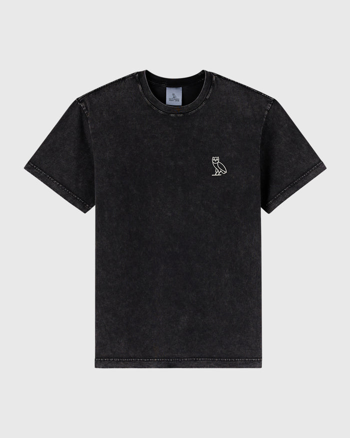 Black garment dyed t-shirt with small owl emblem on chest and distressed edges throughout.