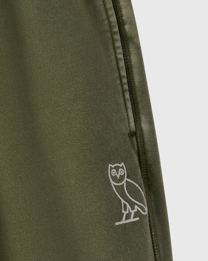 Cypress green sweatpant with white owl embroidery on the leg and drawstring waistband.