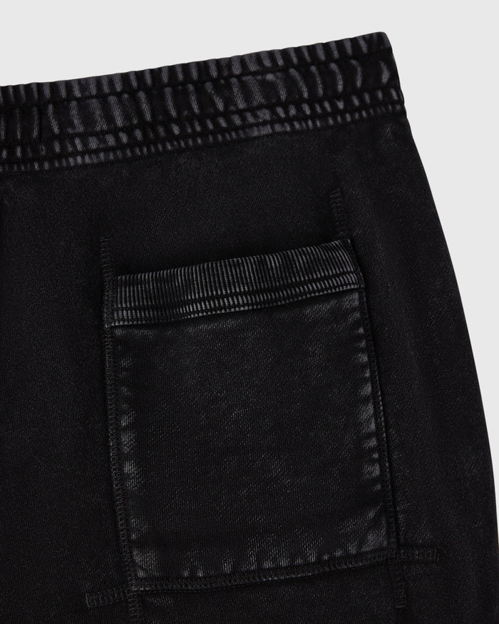 Black sweatpant with striped elastic waistband and patch pocket detail.