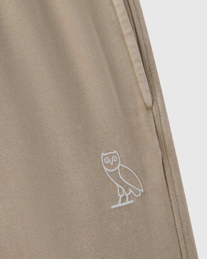Sandstone sweatpant with white owl embroidery on the leg and side seam detail.
