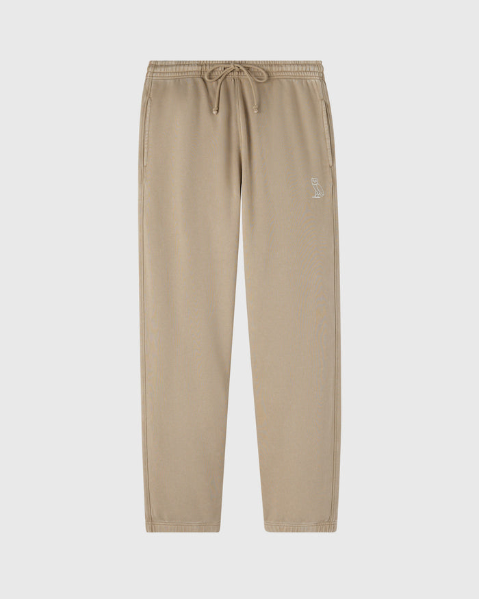 Sandstone-colored sweatpant with drawstring waistband and small embroidered logo on thigh.