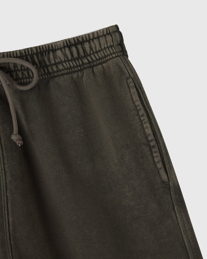 Deep olive sweatshorts with elastic waistband, drawstring, and side seam stitching detail.