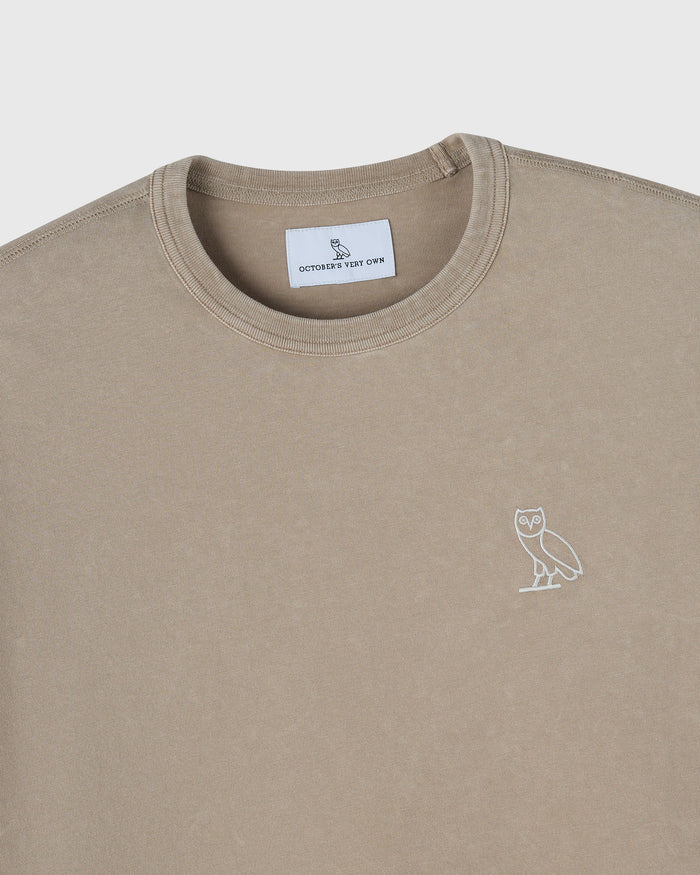 Sandstone crew neck t-shirt with white owl embroidery on chest and brand label at neckline.