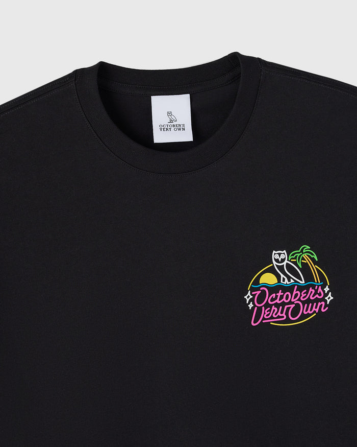 Black t-shirt with neon-style graphic print featuring an owl, palm tree, and "October's Very Own" text on chest.