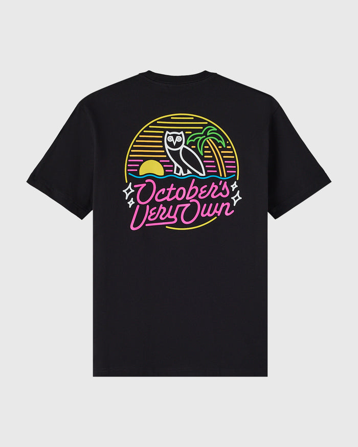 Black t-shirt with neon-style graphic featuring an owl, sun, and "October's Very Own" text in yellow, pink, and green.