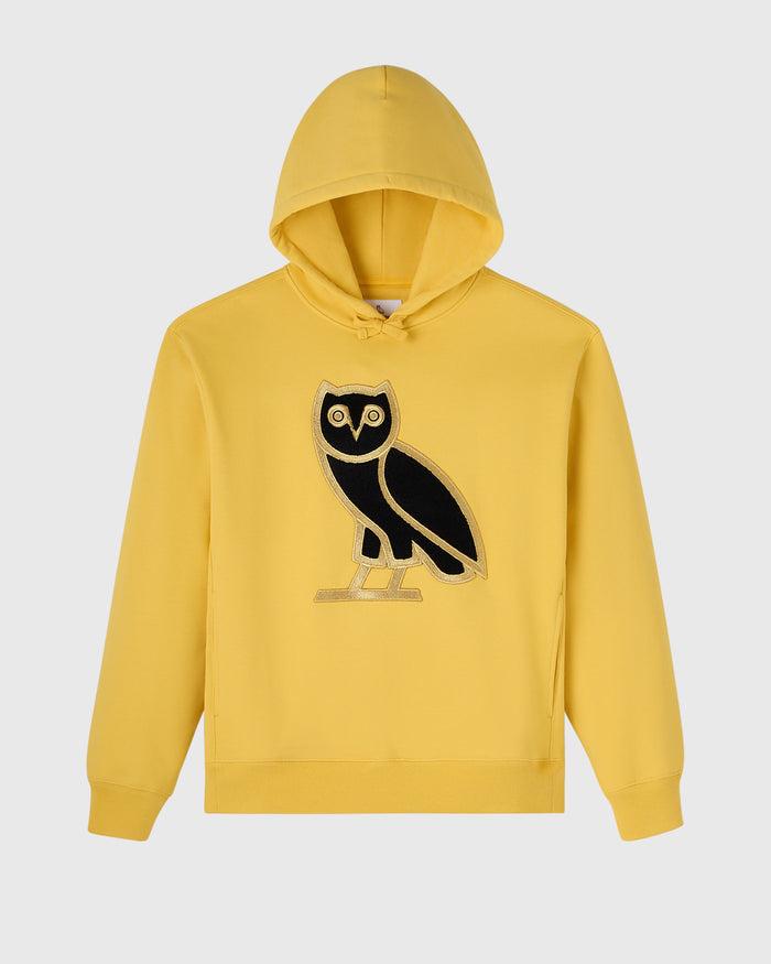 Yellow hoodie with black and gold owl graphic on chest.
