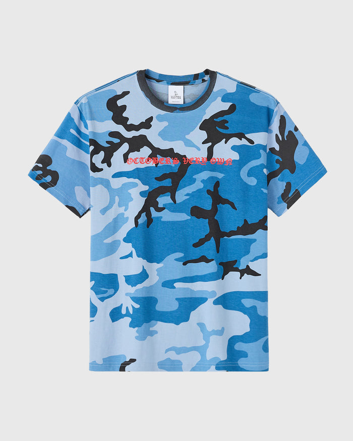 Blue camouflage t-shirt with black and light blue camo pattern and red text on chest.