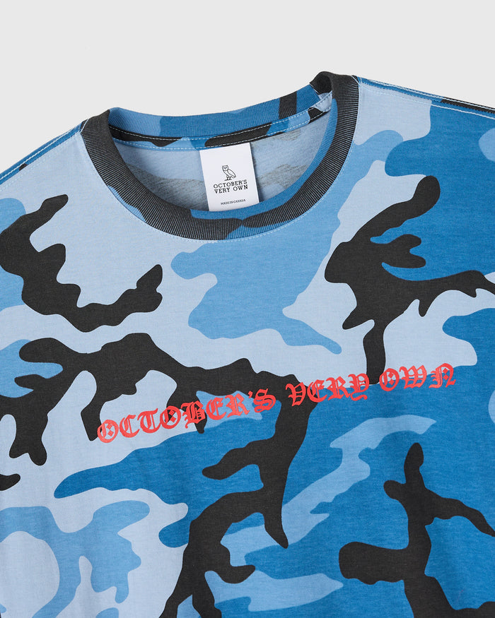 Blue and black camouflage t-shirt with red text reading "October's Very Own" across the chest.