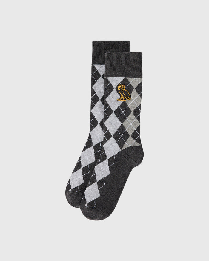 Black and gray argyle crew socks with gold owl emblem on cuff.