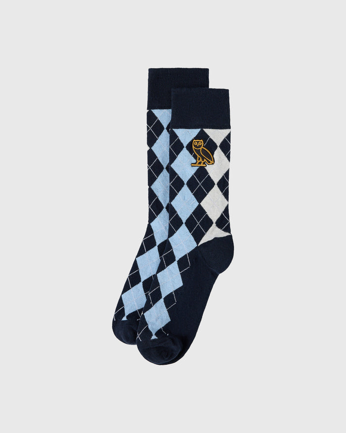 Light blue, black, and white argyle socks with gold owl emblem and dark cuff.