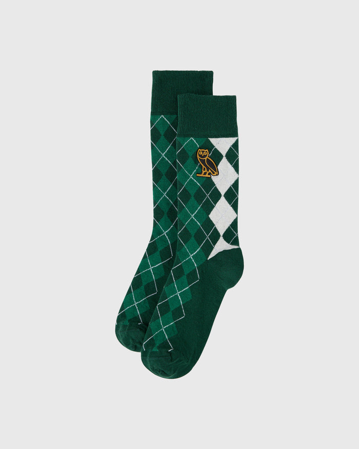 Green argyle crew socks with white diamond pattern and gold owl logo on calf.