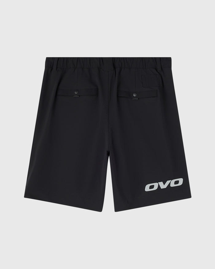 Black stretch nylon golf shorts with elastic waistband, rear pockets, and OVO logo on leg.