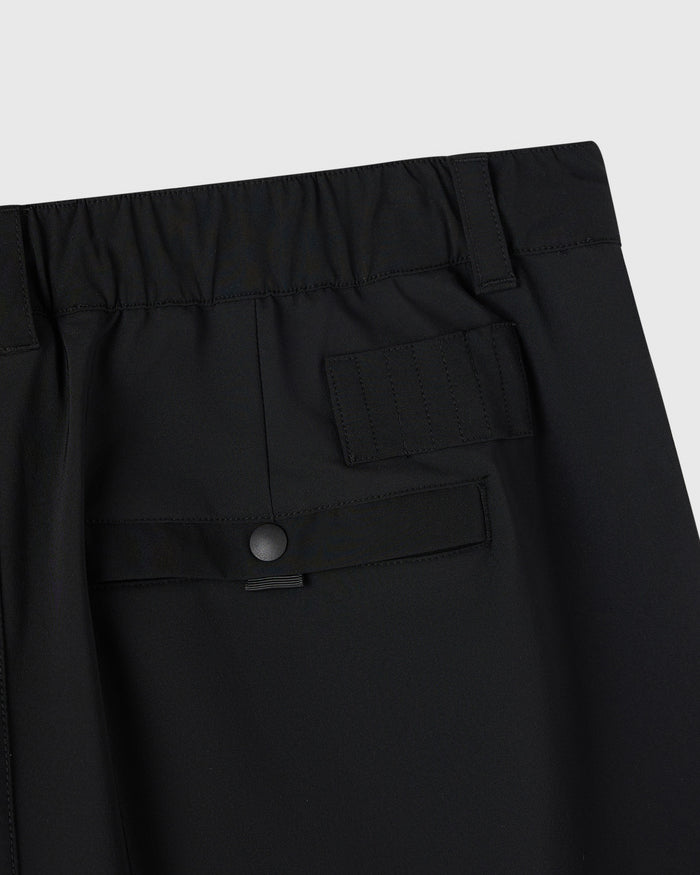 Black golf shorts with multiple pockets and button waistband closure.
