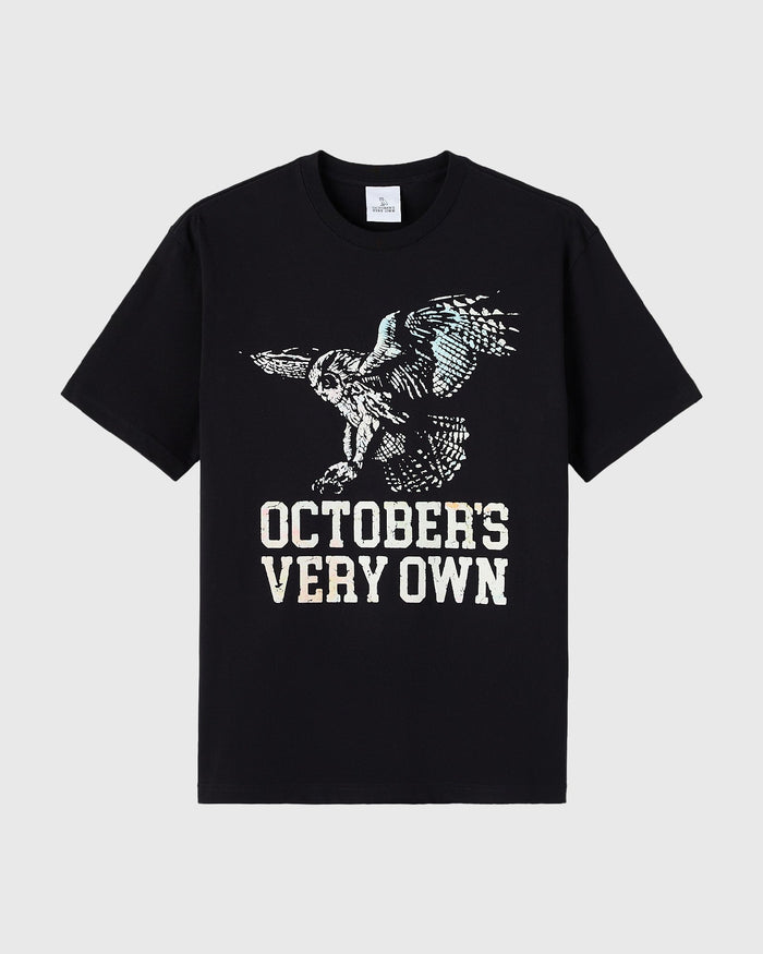 Black short-sleeve t-shirt with white puff print owl graphic and "October's Very Own" text on chest.